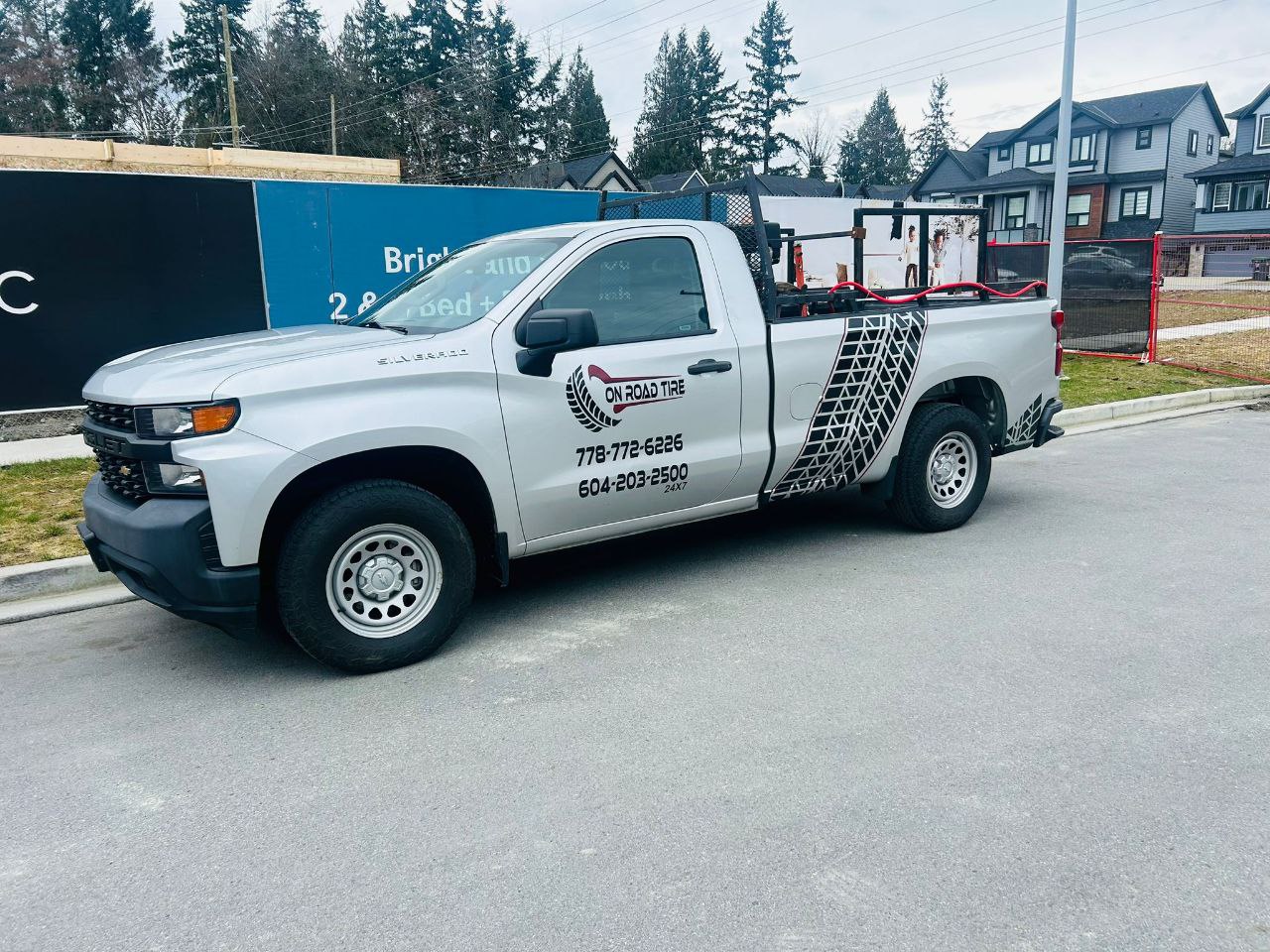 Truck service workers with new tires at the shop